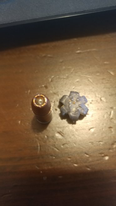 Unfired Speer Gold Dot next to a recovered, expanded Gold Dot projectile